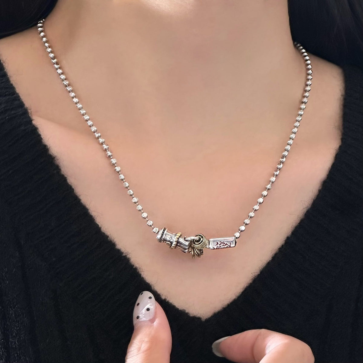 TaoWards Daoist blade bead chain necklace worn with a black top