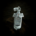 TaoWards yin-yang sword pendant shown on its own against dark wood.