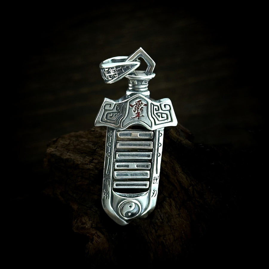 TaoWards yin-yang sword pendant shown on its own against dark wood.