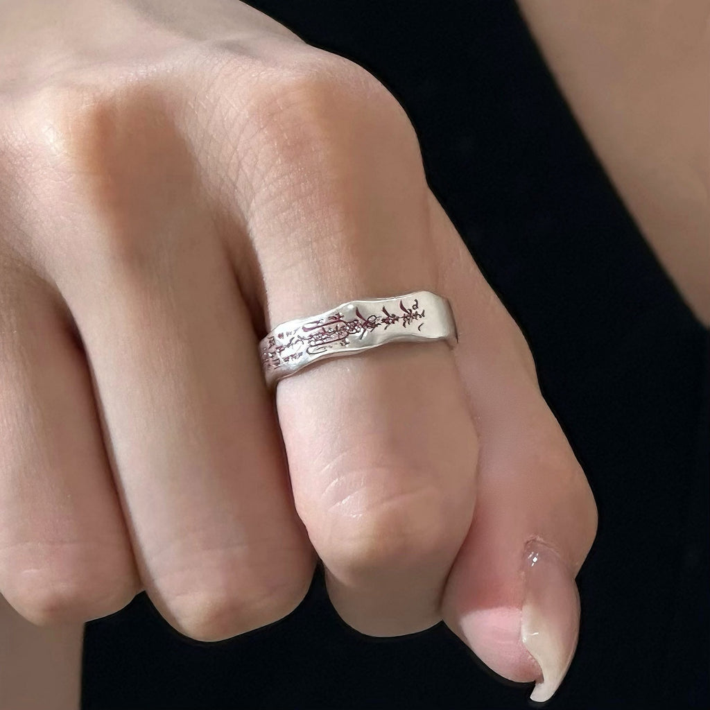 TaoWards inscription open ring worn on a hand.