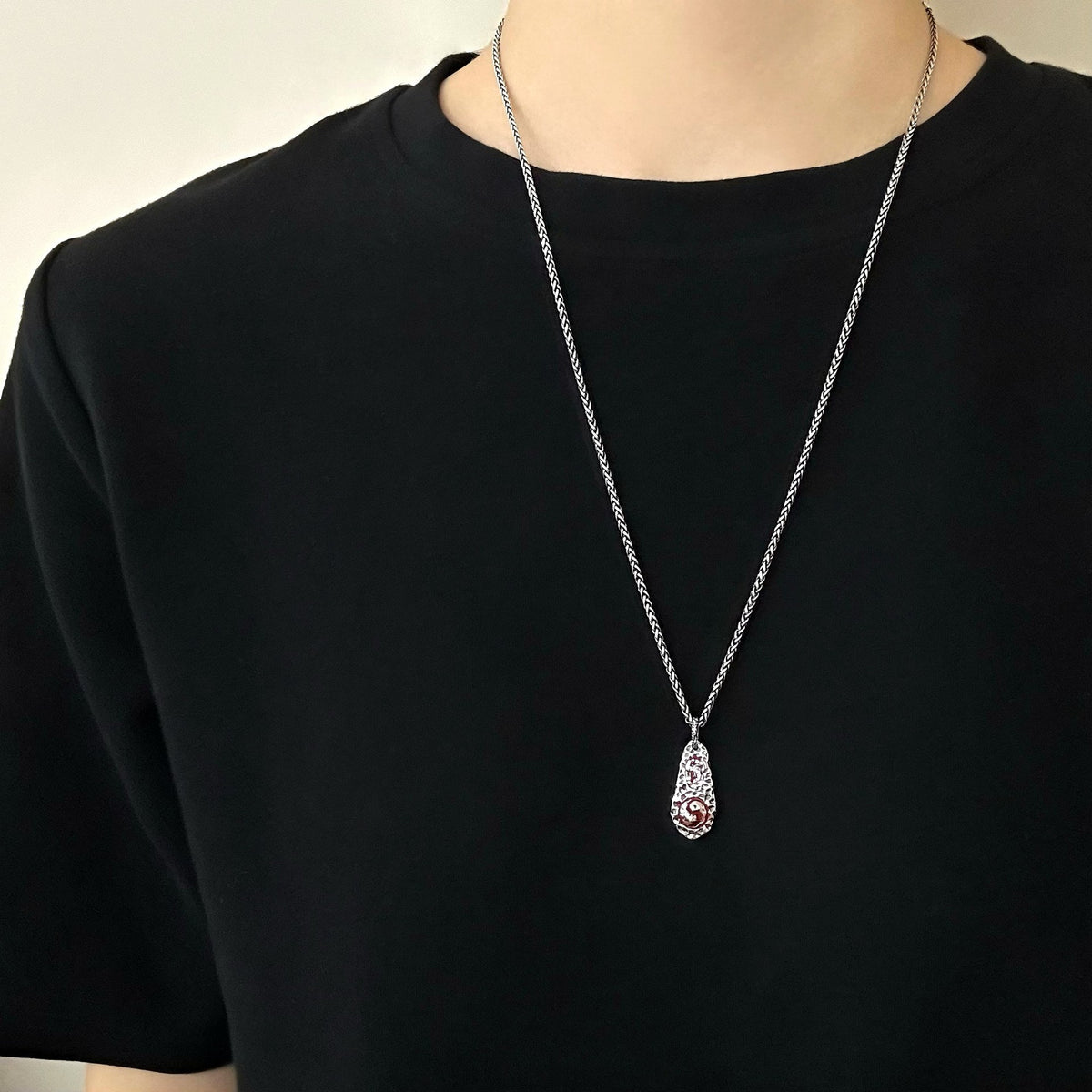 TaoWards teardrop pendant worn over a black shirt; chain not included