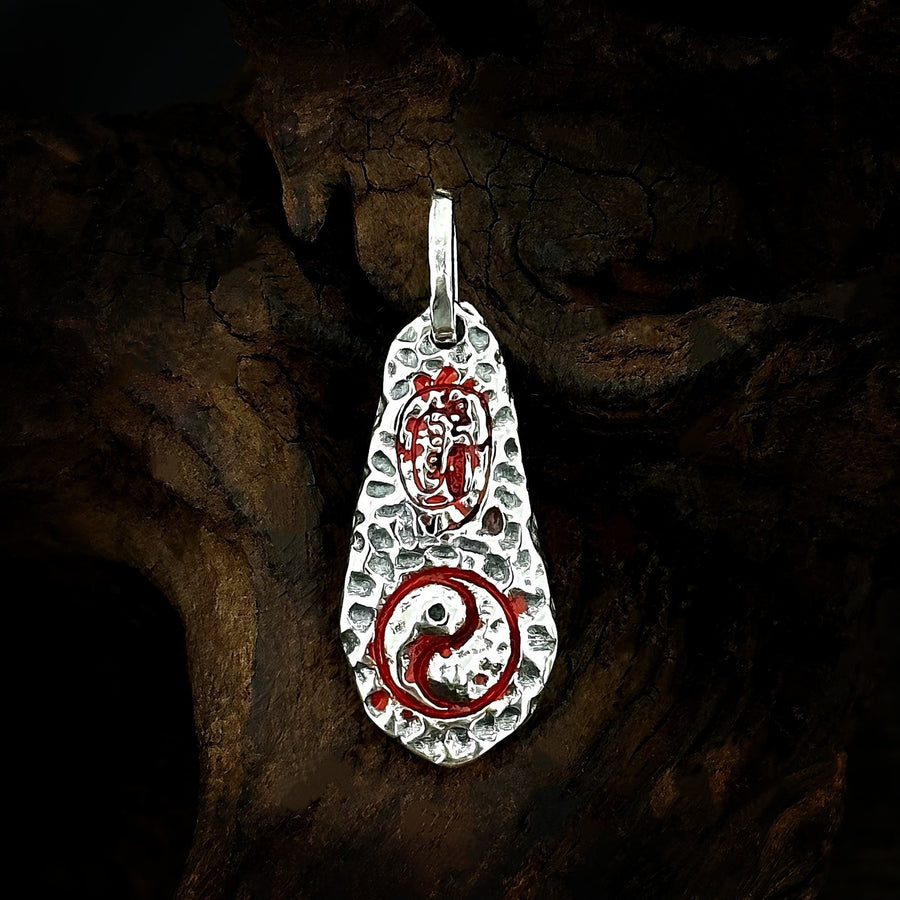 Front of TaoWards teardrop pendant with red motifs