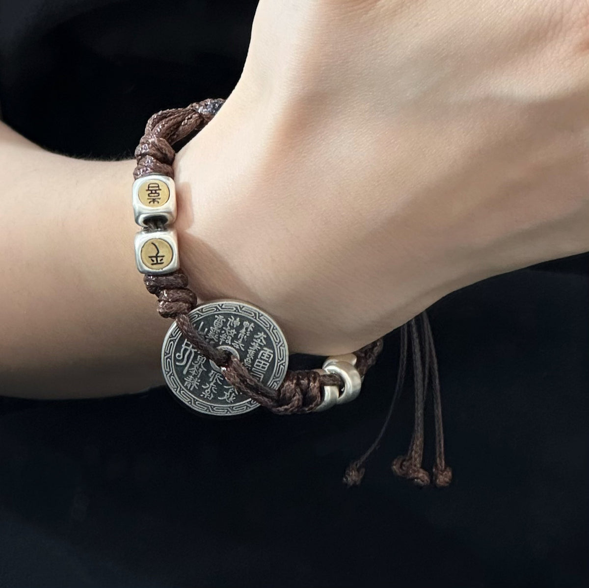 TaoWards coin braided cord bracelet worn on the wrist
