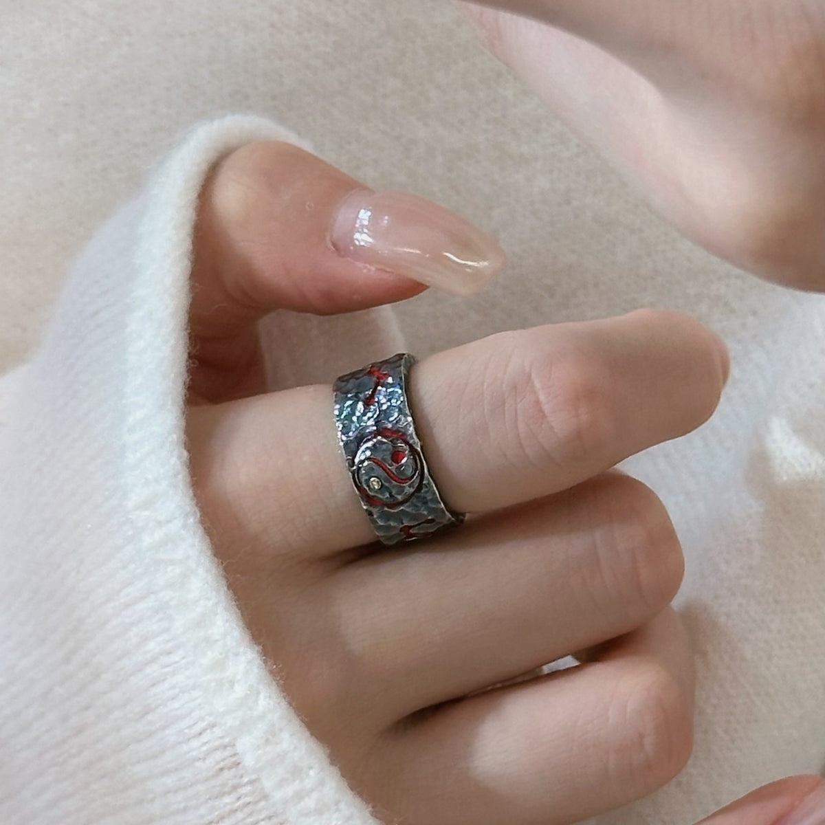 TaoWards wide textured ring shown on the hand