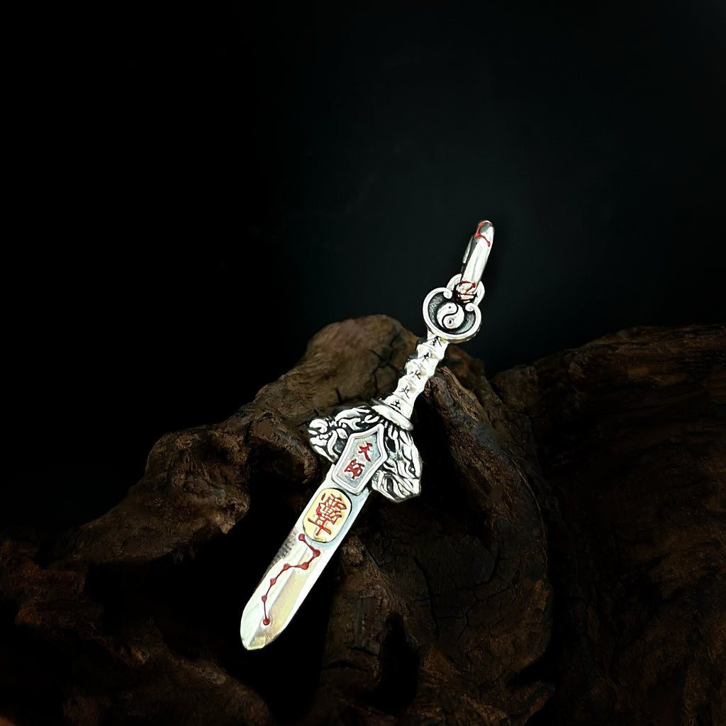 TaoWards sword pendant shown at an angle on dark wood