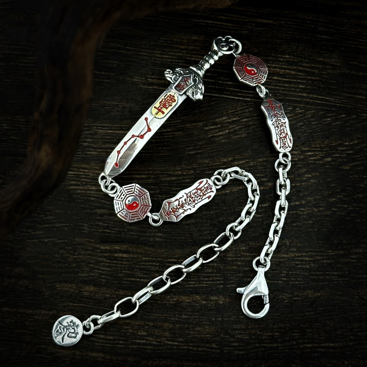 Full TaoWards Seven Star Sword Bracelet with clasp and extension chain on dark wood.