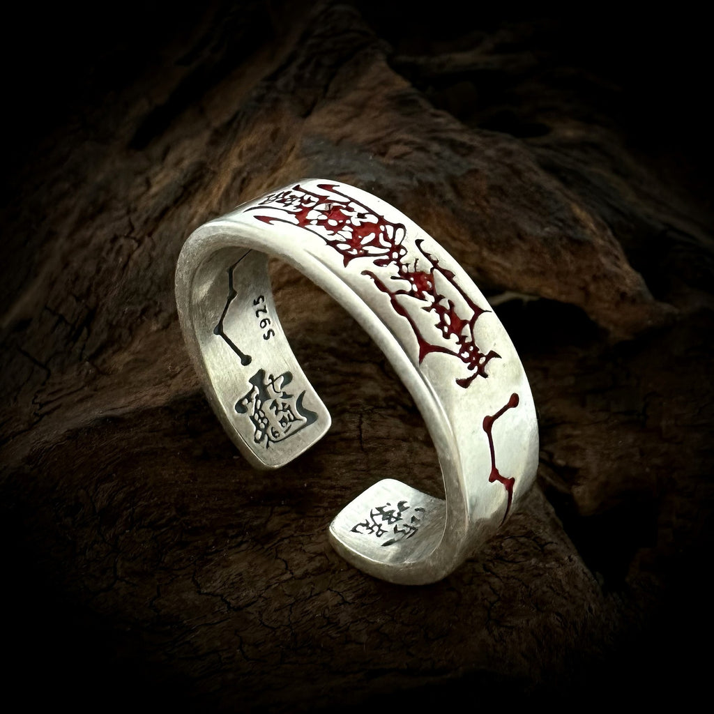 TaoWards red engraved open ring on a dark wood background