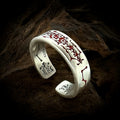 TaoWards red engraved open ring on a dark wood background