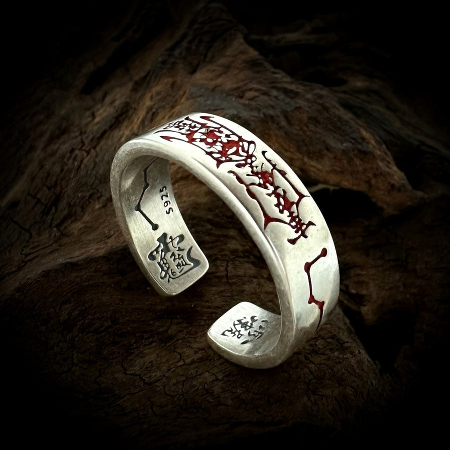 TaoWards red engraved open ring on a dark wood background