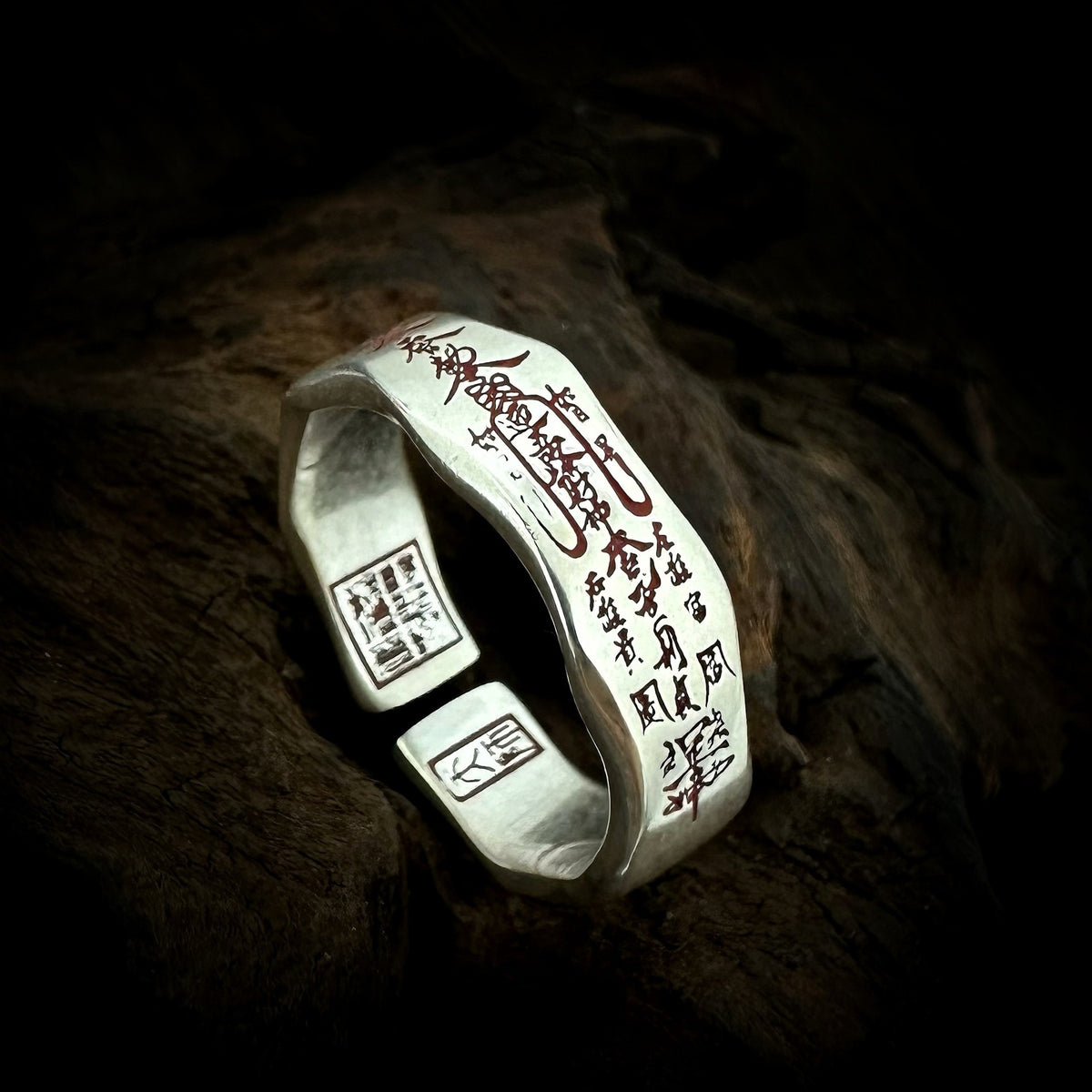 TaoWards Five Wealth Gods Open Ring with red inscriptions on dark wood.