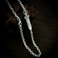 Close-up of the sword detail, angular chain links and lobster clasp on the TaoWards necklace.