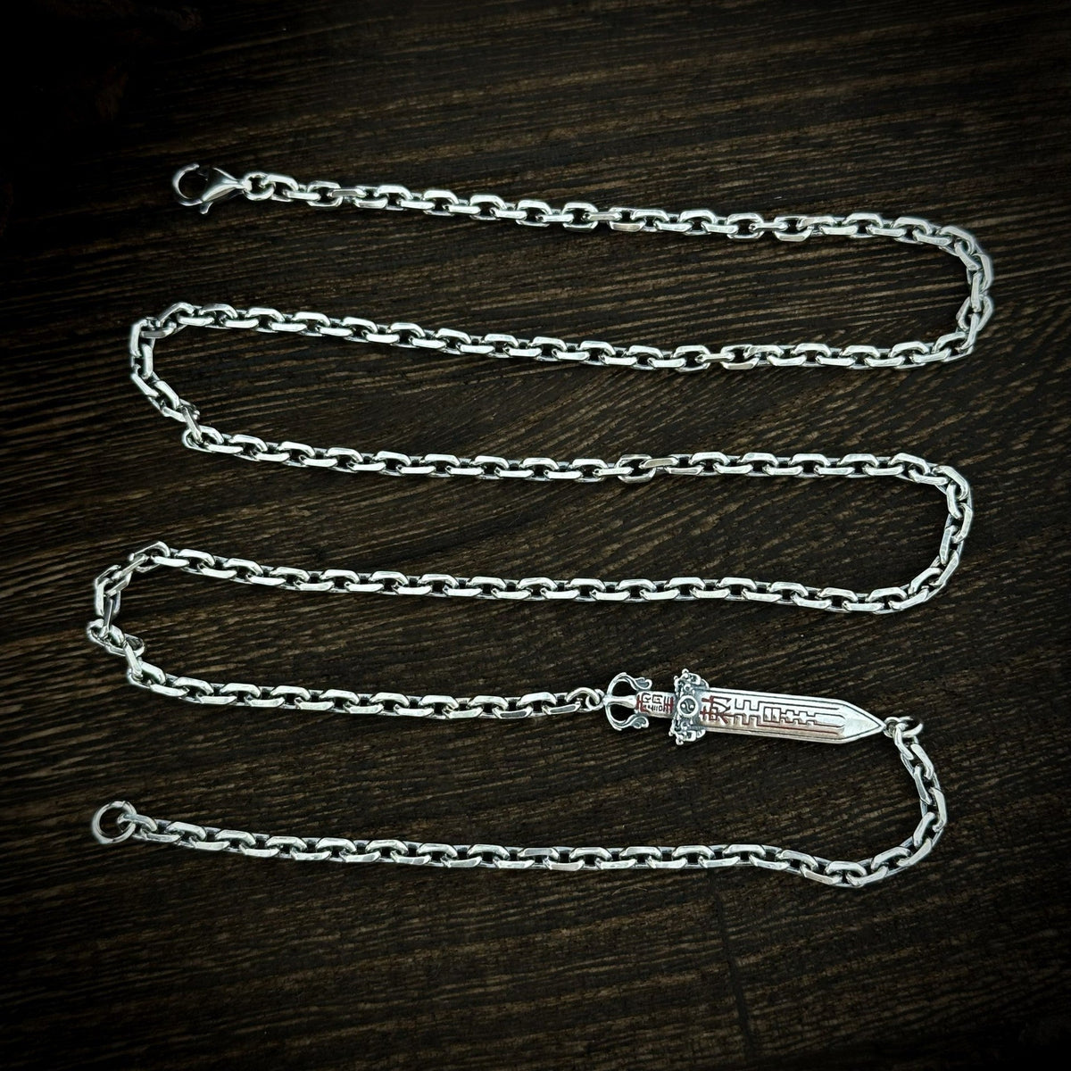 TaoWards sword chain necklace laid flat, showing the full chain and lobster clasp.