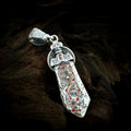 Front of the TaoWards Seven Star Sword Coin Pendant, shown on dark wood.