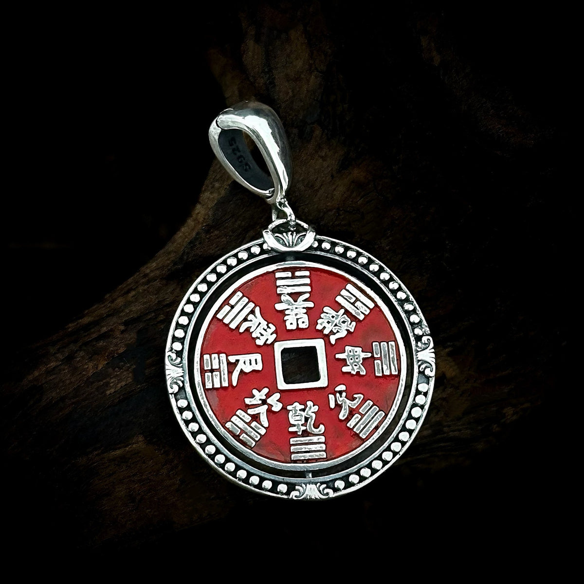 Bagua reverse of TaoWards red coin pendant on dark wood