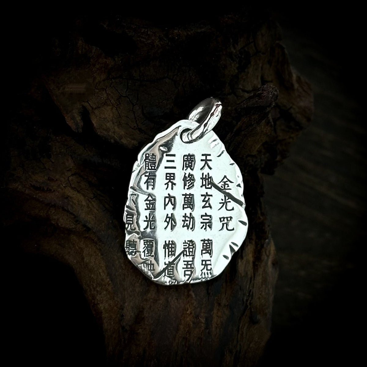 Chinese-character engraving on the back of TaoWards oval pendant