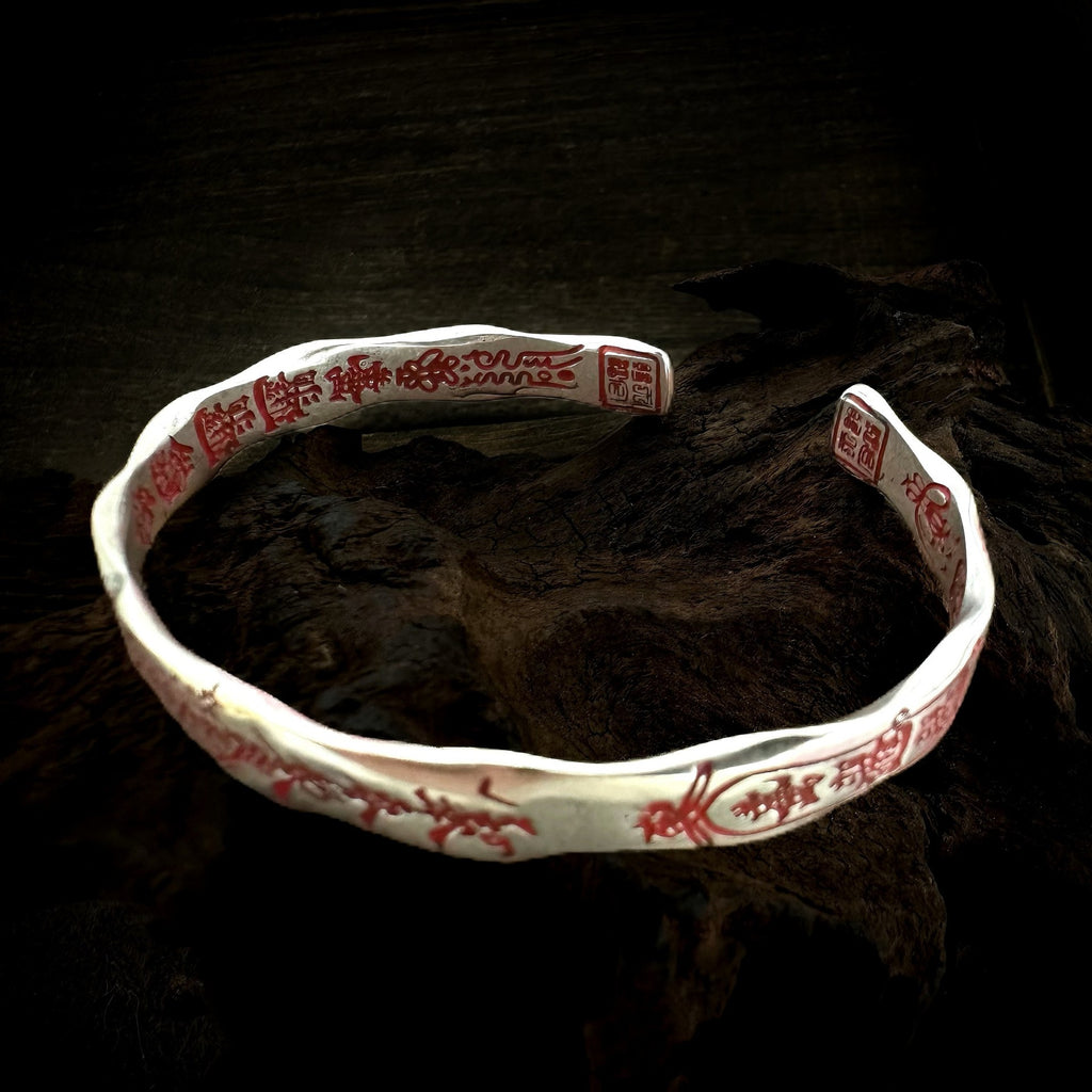 Open view of TaoWards Five Deities Cuff Bracelet showing red inner and outer engraving